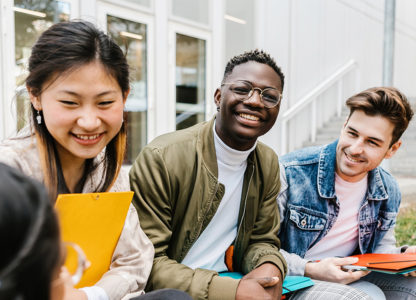 three students laughing and smiling